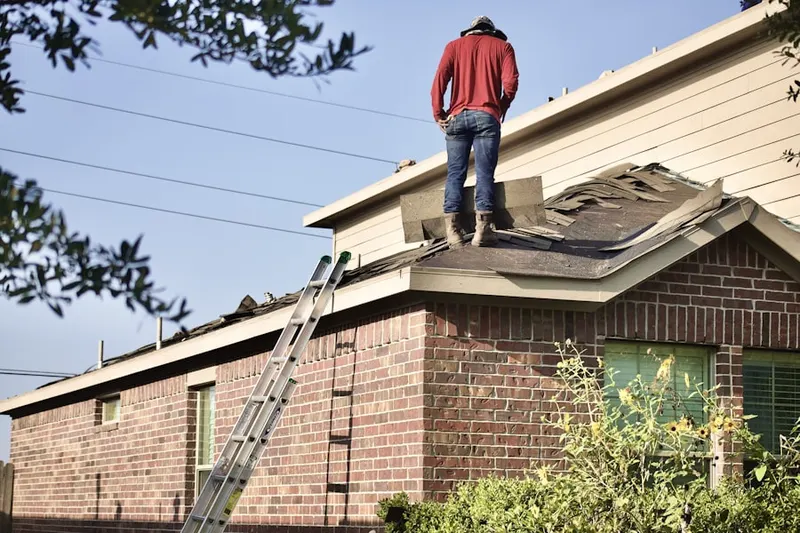 Professional roofer working on a residential roof in Fleetwood